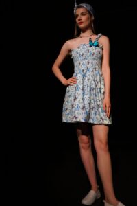 Model wearing a dress with a blue butterfly print.