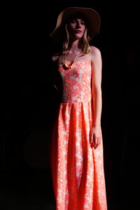 Model wearing strapless sundress.