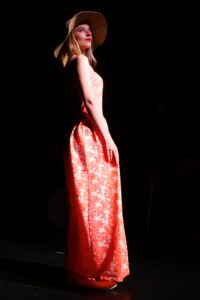 Model wearing strapless sundress.