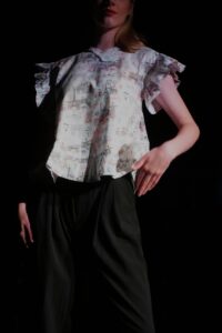 Model wears a pretty Parisian print shirt.