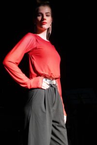 Model wears a long sleeve red mesh top.
